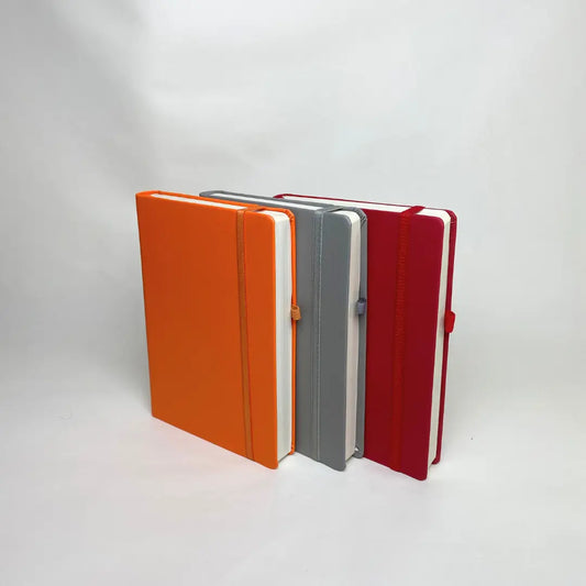 Four A5 hardbound notebook in blue, black, white, and black with a pen holder on a white background